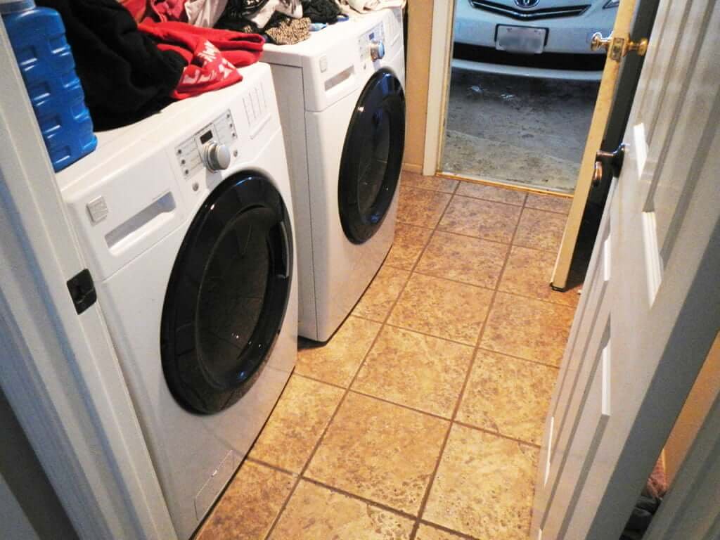 washer and dryer with mess above, tile floor