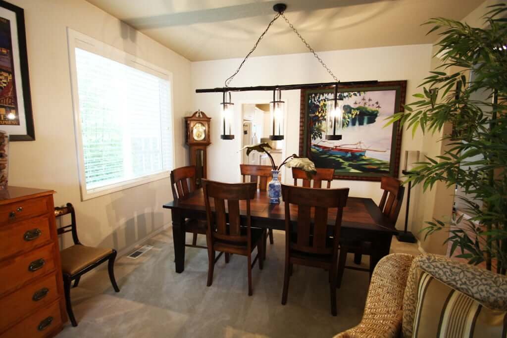 Dining room after with white walls updated chandelier and dining table