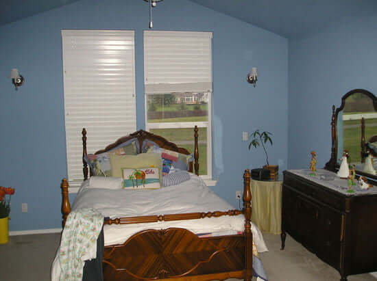Master Bedroom with blue walls and ceiling and bed in front of windows