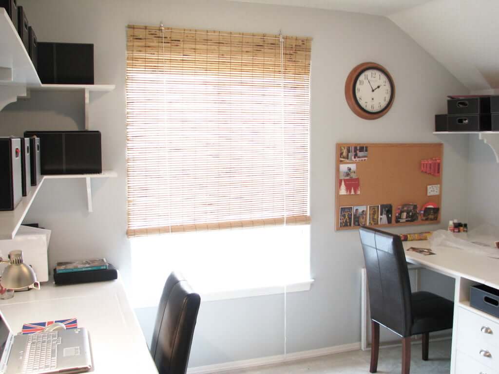 Office with light blue/grey walls custom desks and shelving, bamboo blinds
