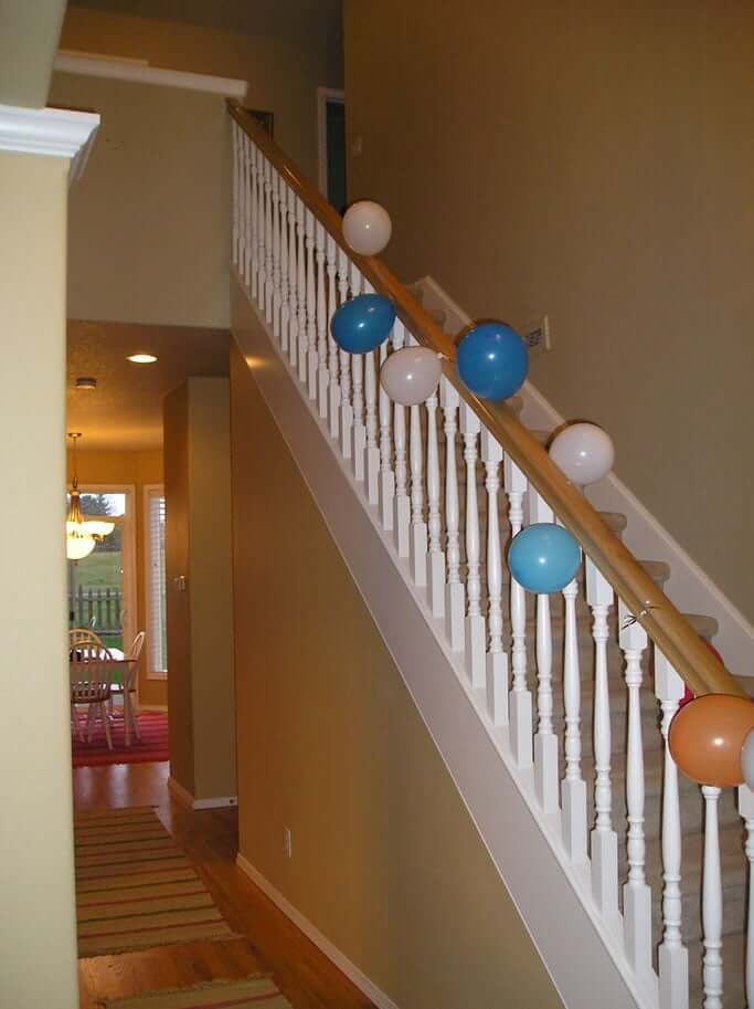 Stairway with yellow walls and white railing