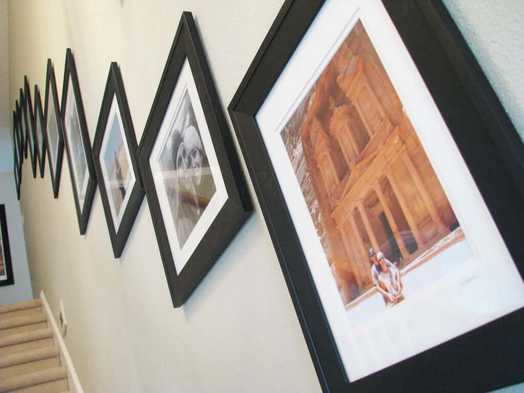 Stairway wall with framed photos up the stairs