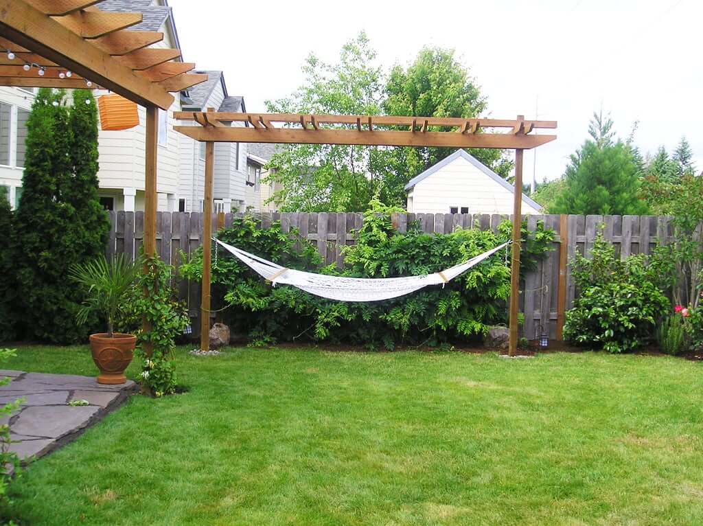 View of hammock under arbor with wisteria