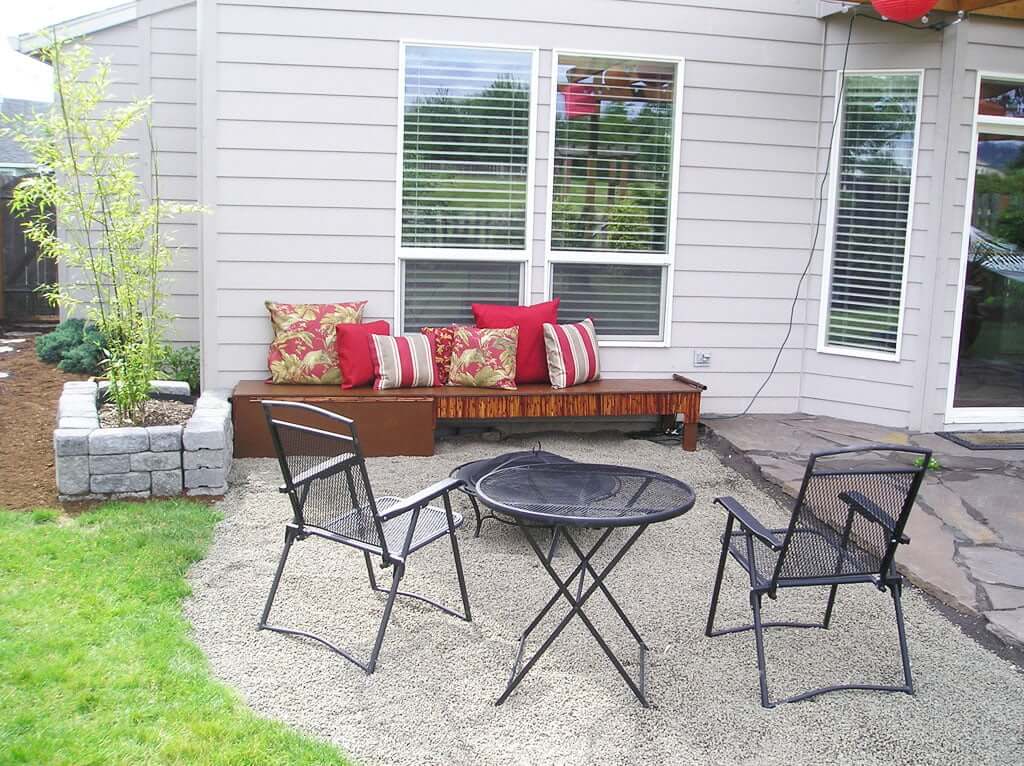 Gravel seating pit with firepit bench and  table and chairs
