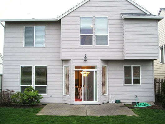 Back of house view with sliding door to concrete patio