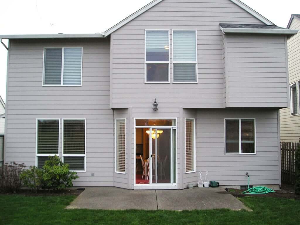 Back of house showing concrete pad and sliding door from house