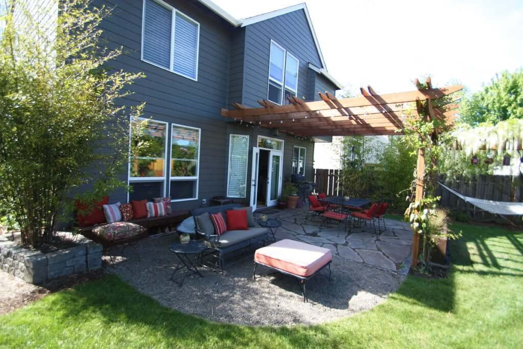 view of back of house from side showing seating areas, arbor and bamboo