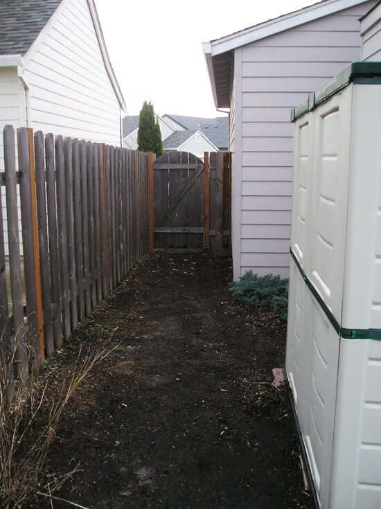 Side yard previous view of dirt and gate