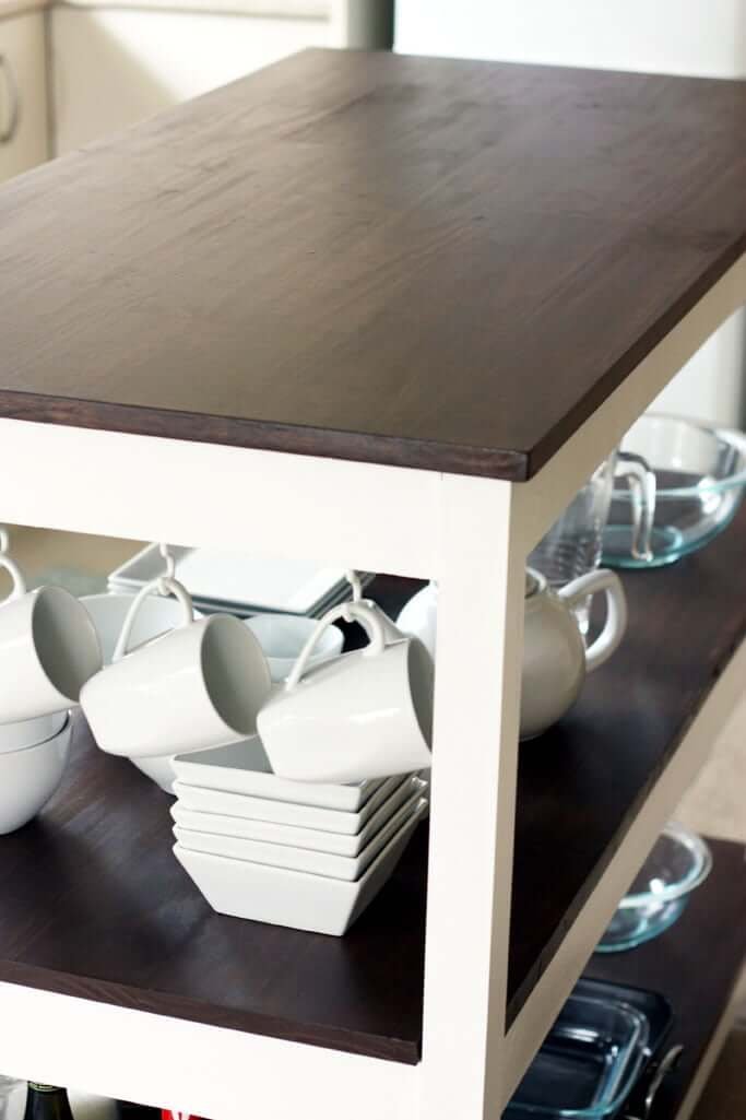 Kitchen island cart with dishes on shelves