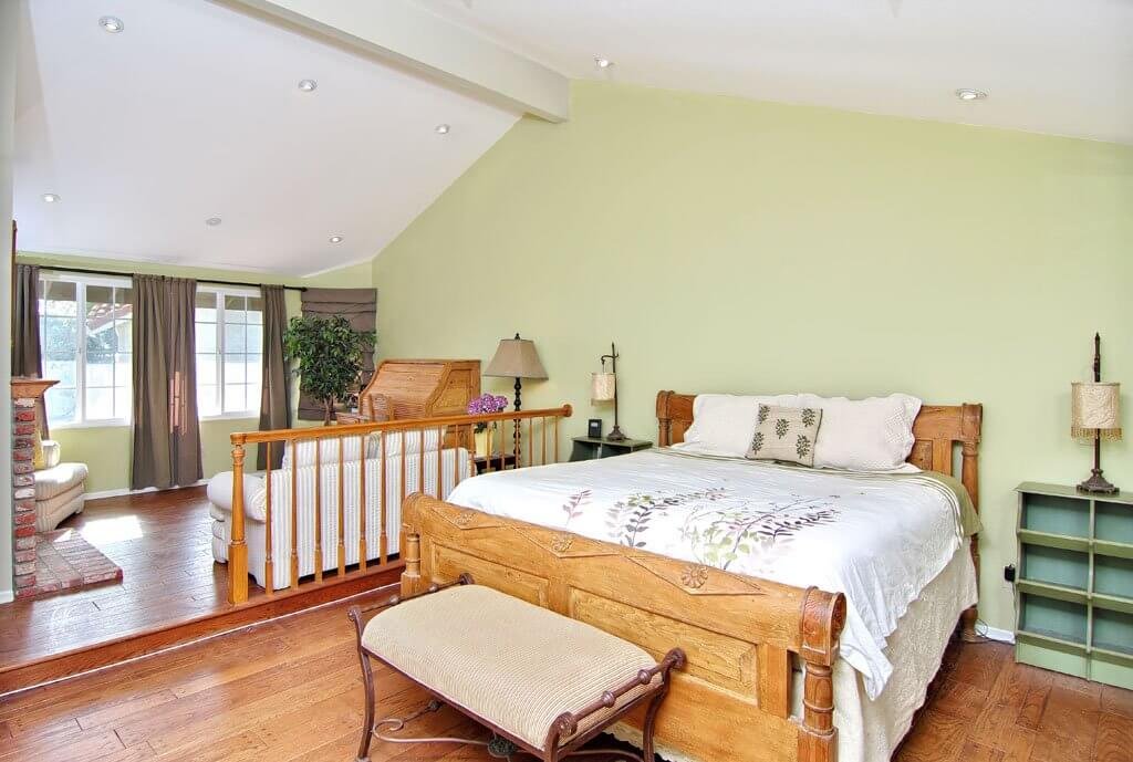 Master bedroom with bed nightstands and sitting area