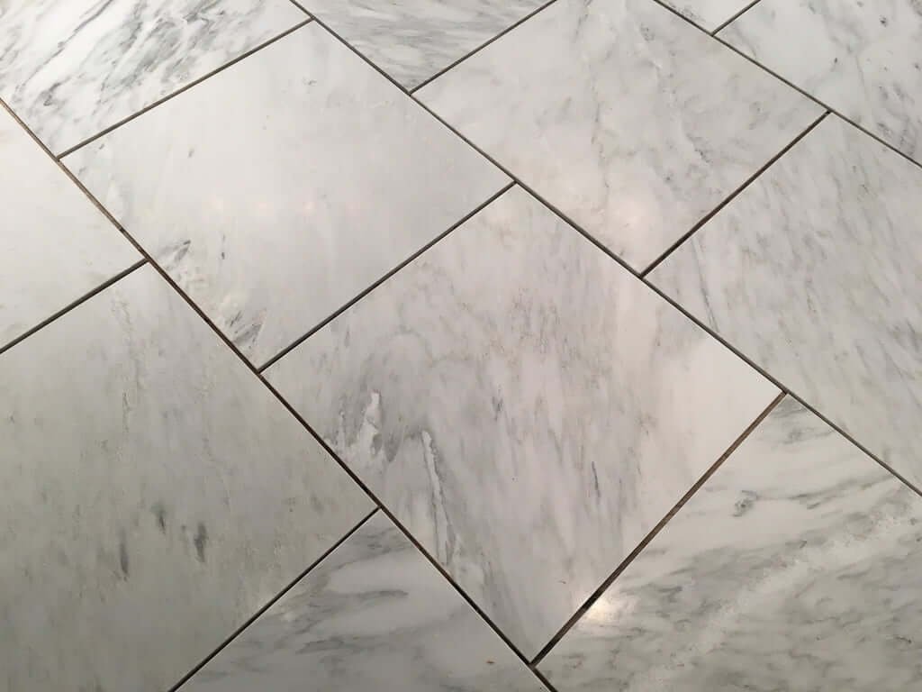 Marble tile laid out on floor in brick pattern