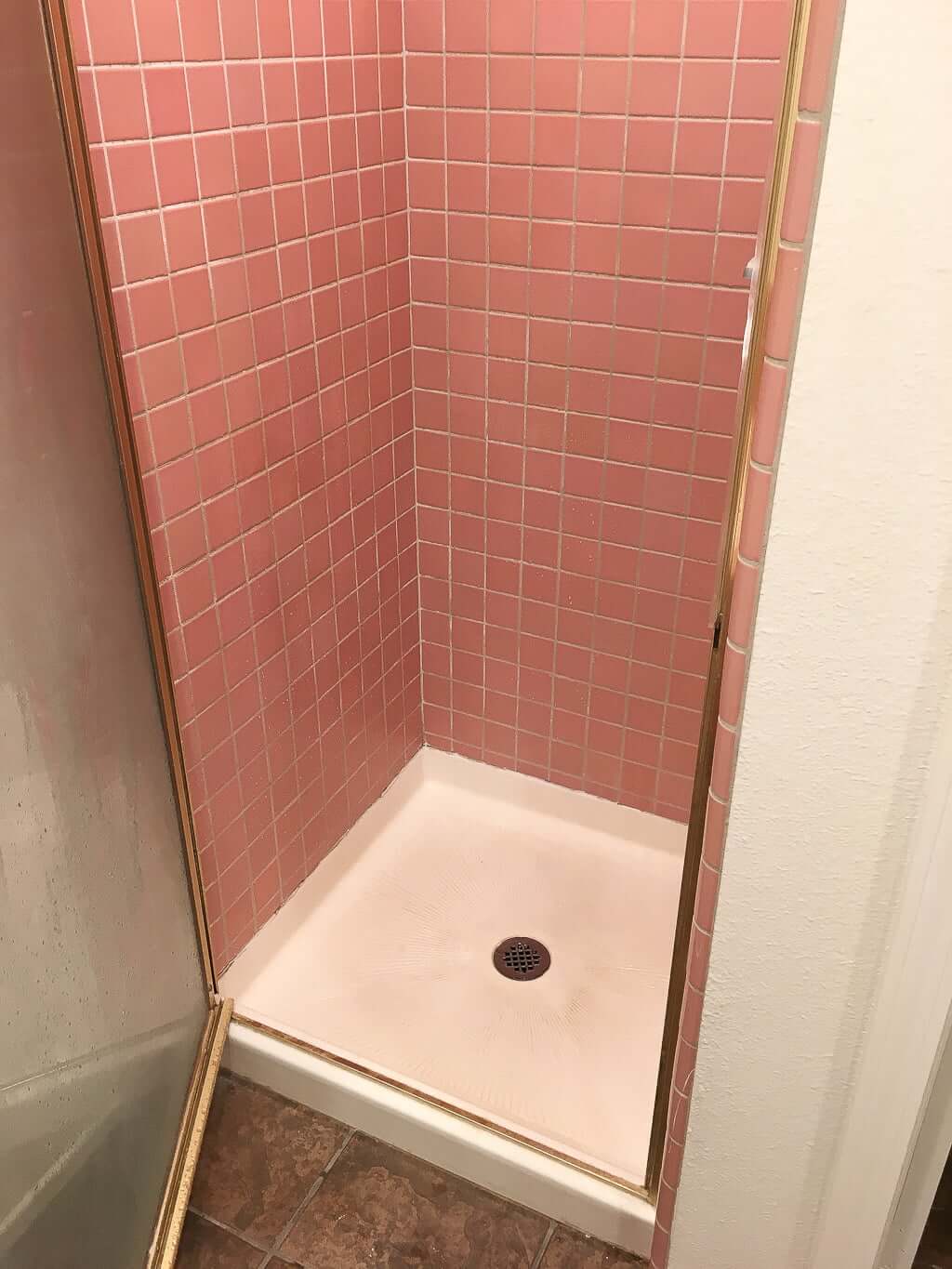 bathroom shower, narrow with pink tile