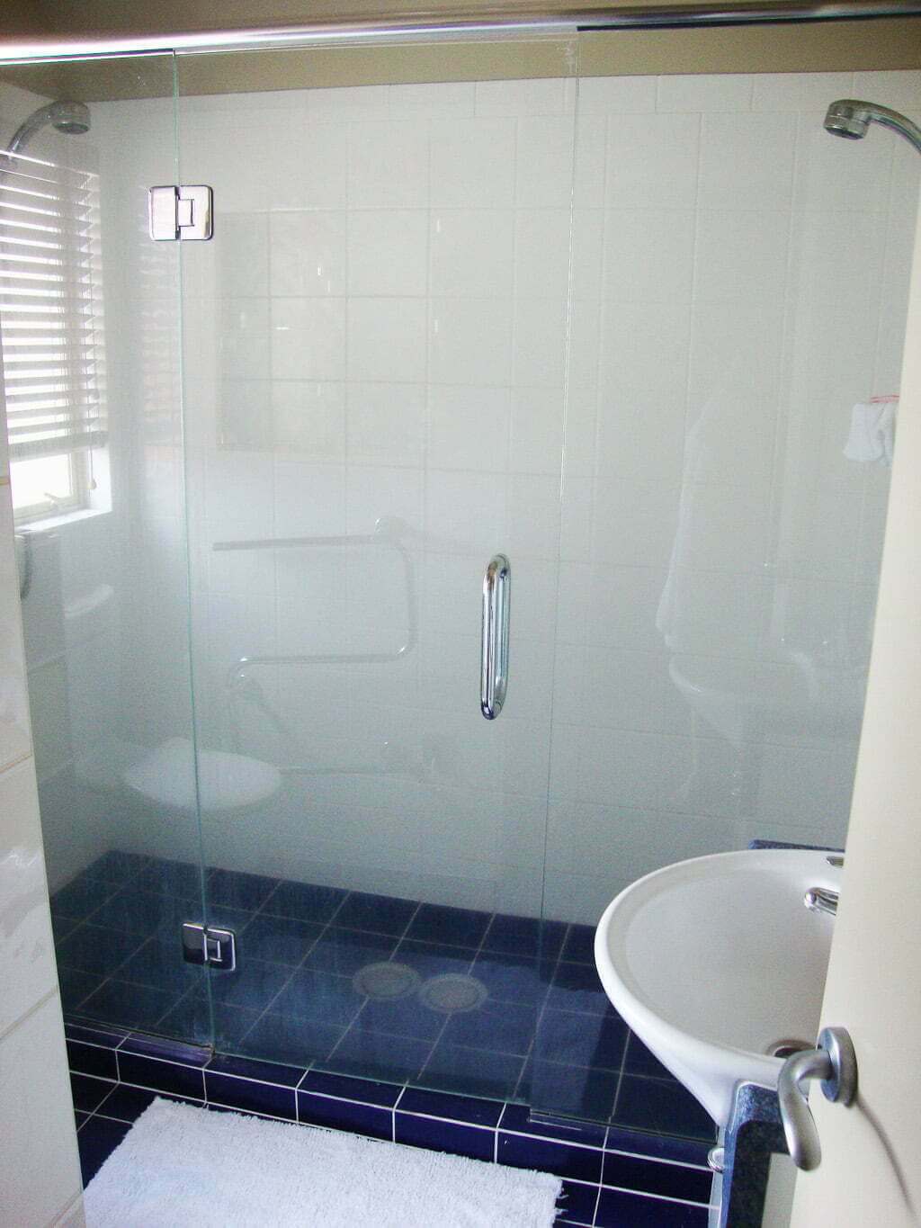 shower with blue tile and double showerheads