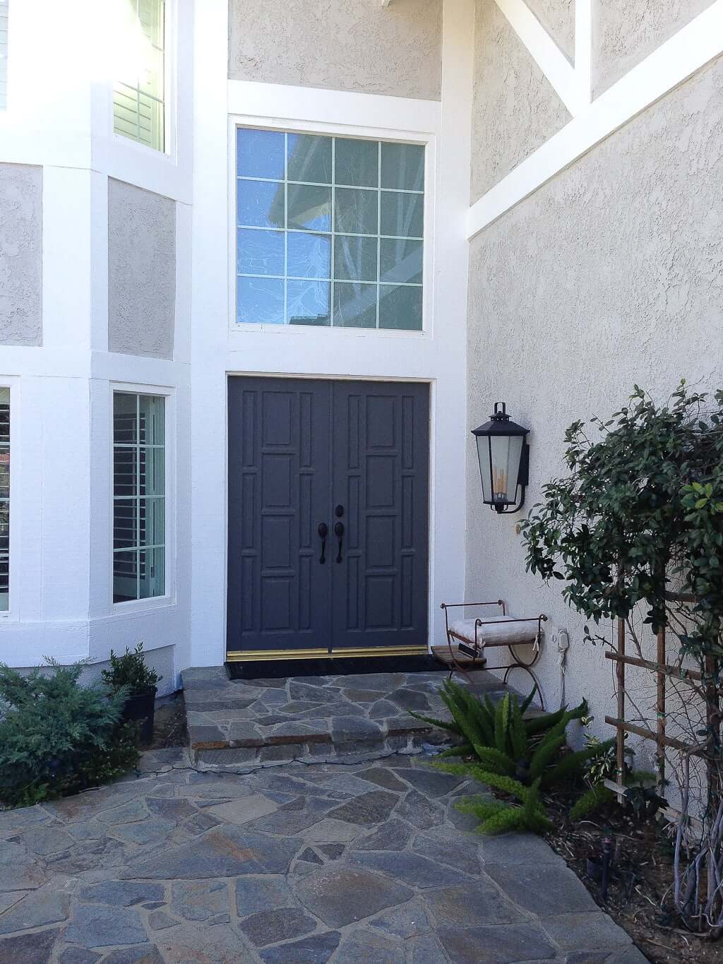 house entryway with grey door and flagstone patio