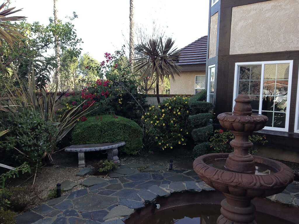 courtyard with plants and stone bench seat