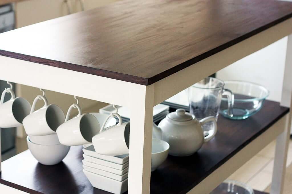 Kitchen island cart with top and dishes underneath