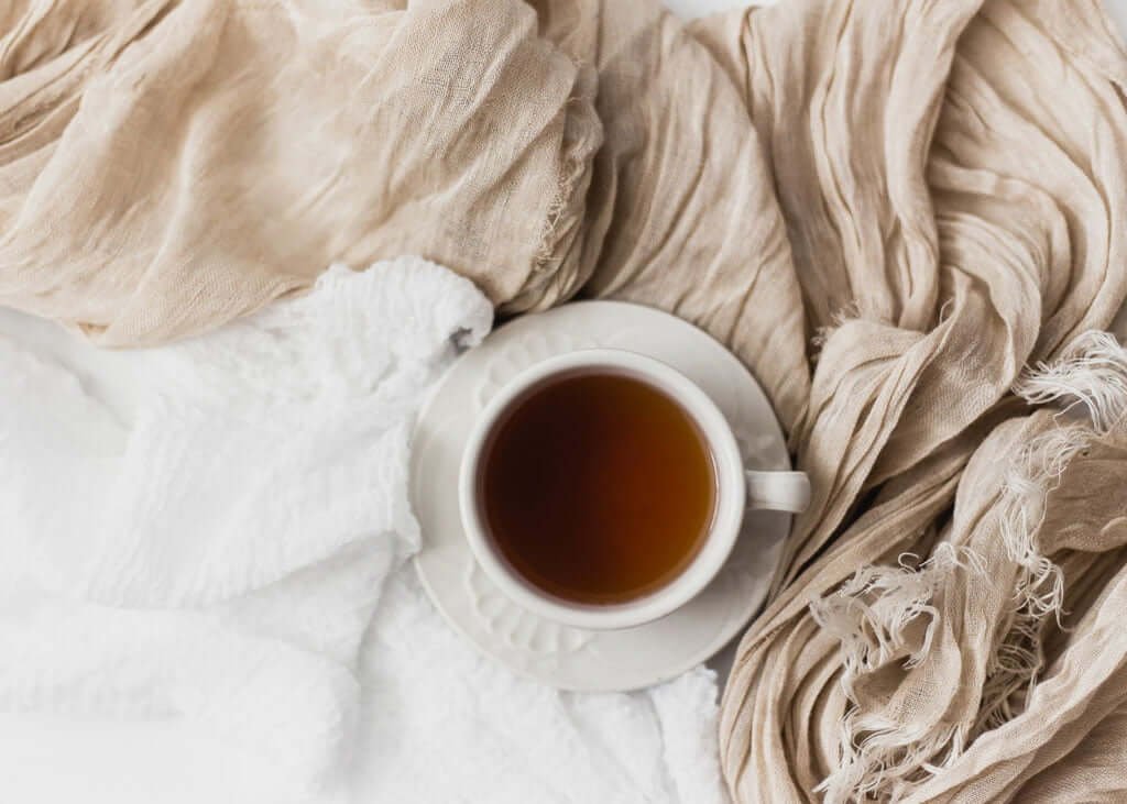 tea surrounded by blankets