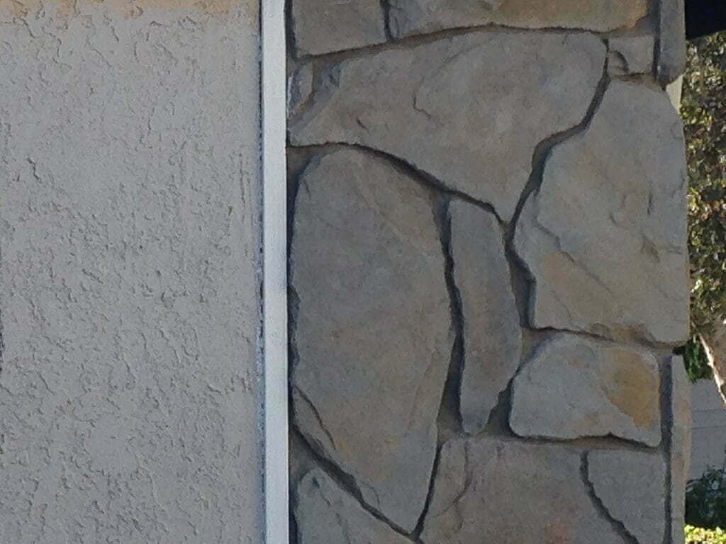 grey house exterior paint color testing on stucco next to veneer