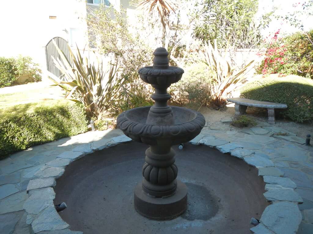 brown fountain in flagstone patio
