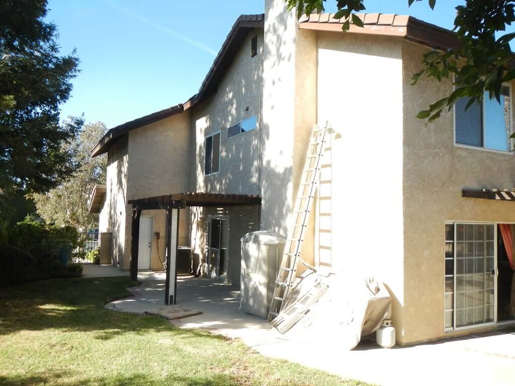 view of stucco two-story house