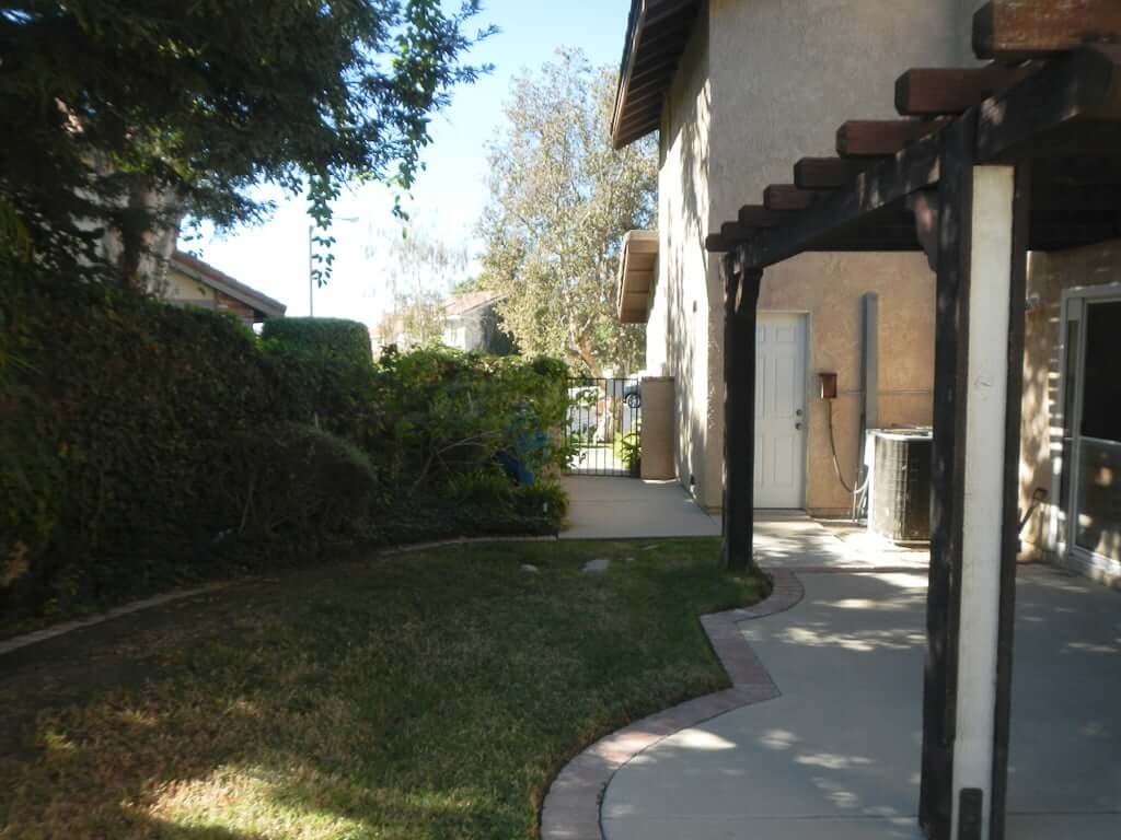 side yard with pergola and gate to front of house