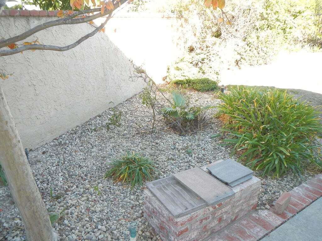 scant landscaping with rocks on ground