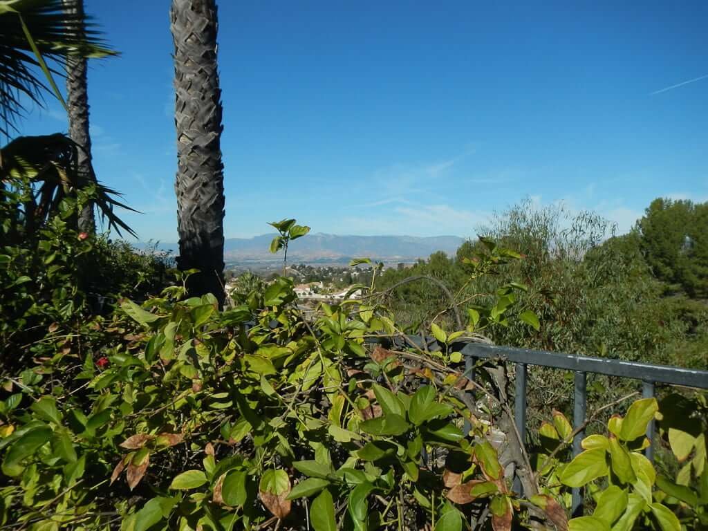 view over fence to mountains in distance