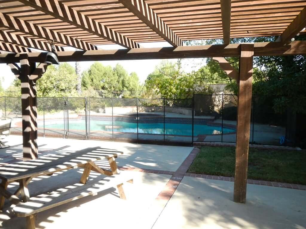 backyard patio with arbor and pool