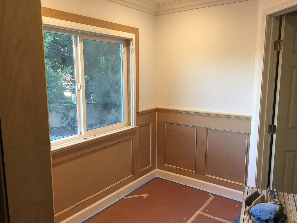 wainscoting installed with framing around window and all caulked