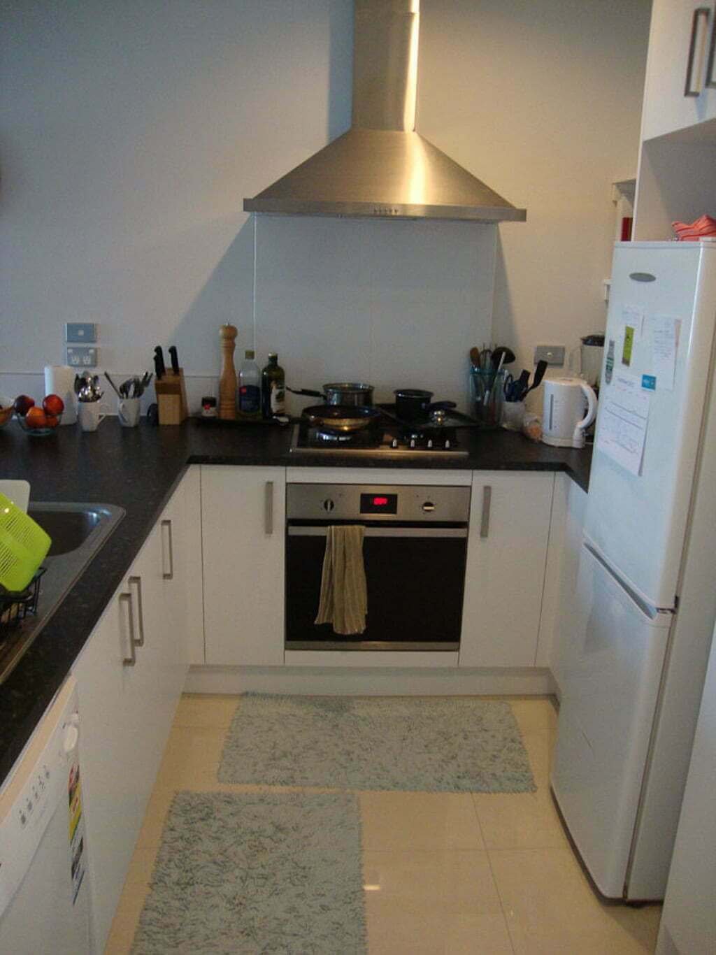 kitchen with stainless steel hood stove, oven and refrigerator