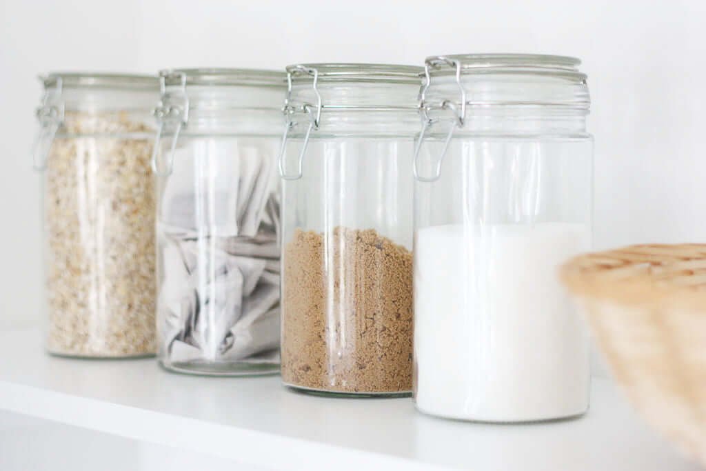 Tea containers and sugar on shelf