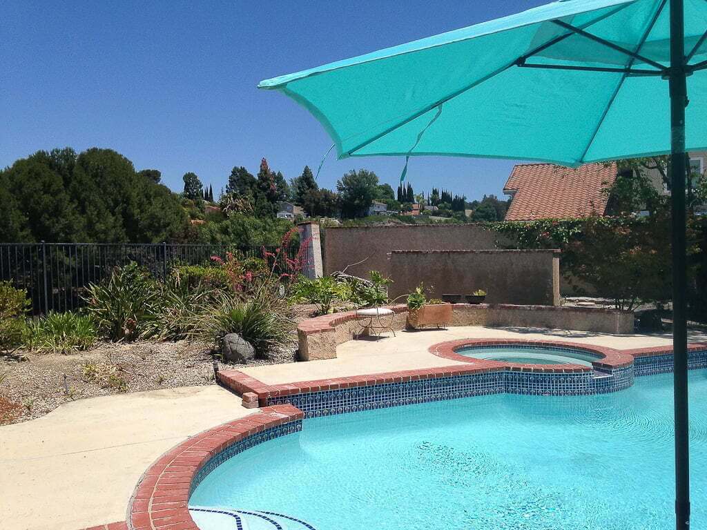 backyard pool with umbrella