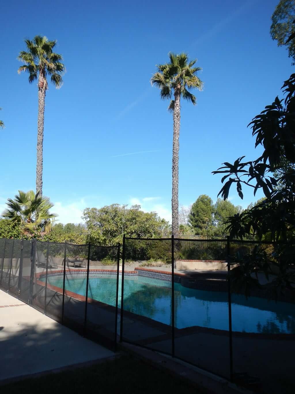 view of pool through removable pool fence