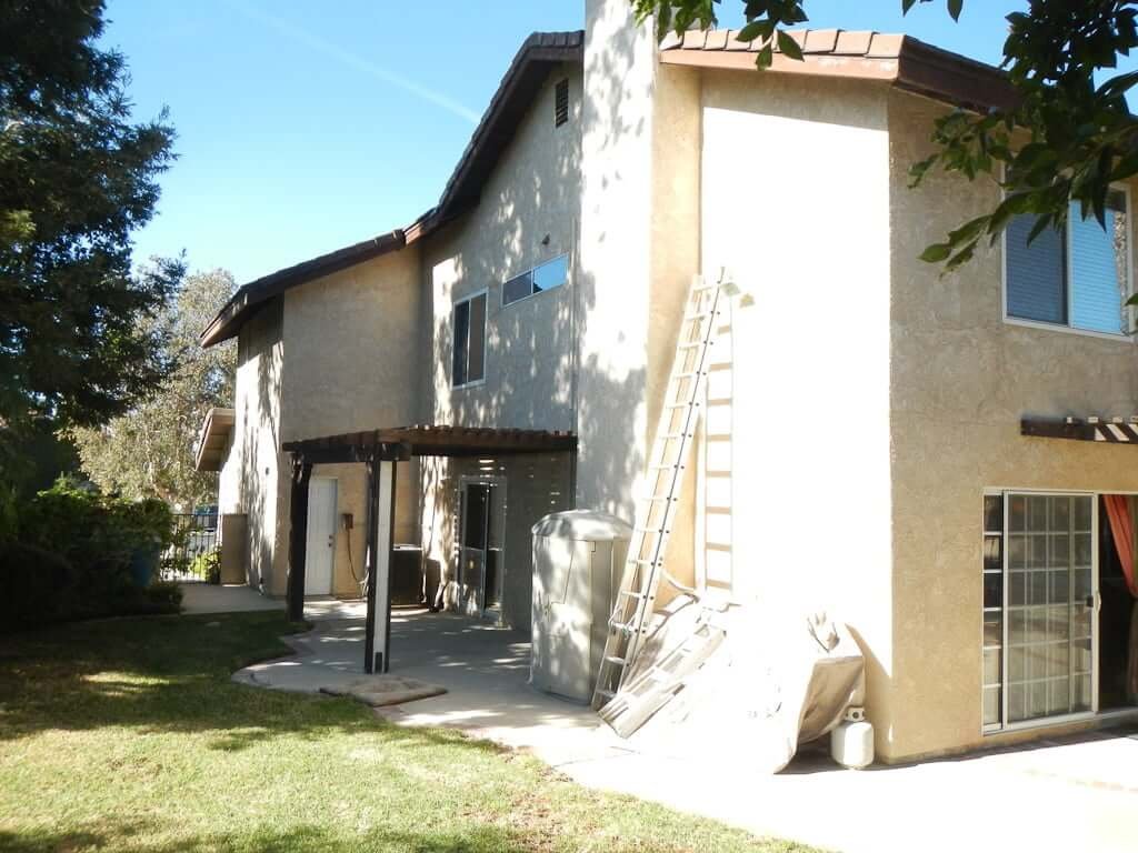 two story house with side yard and lawn