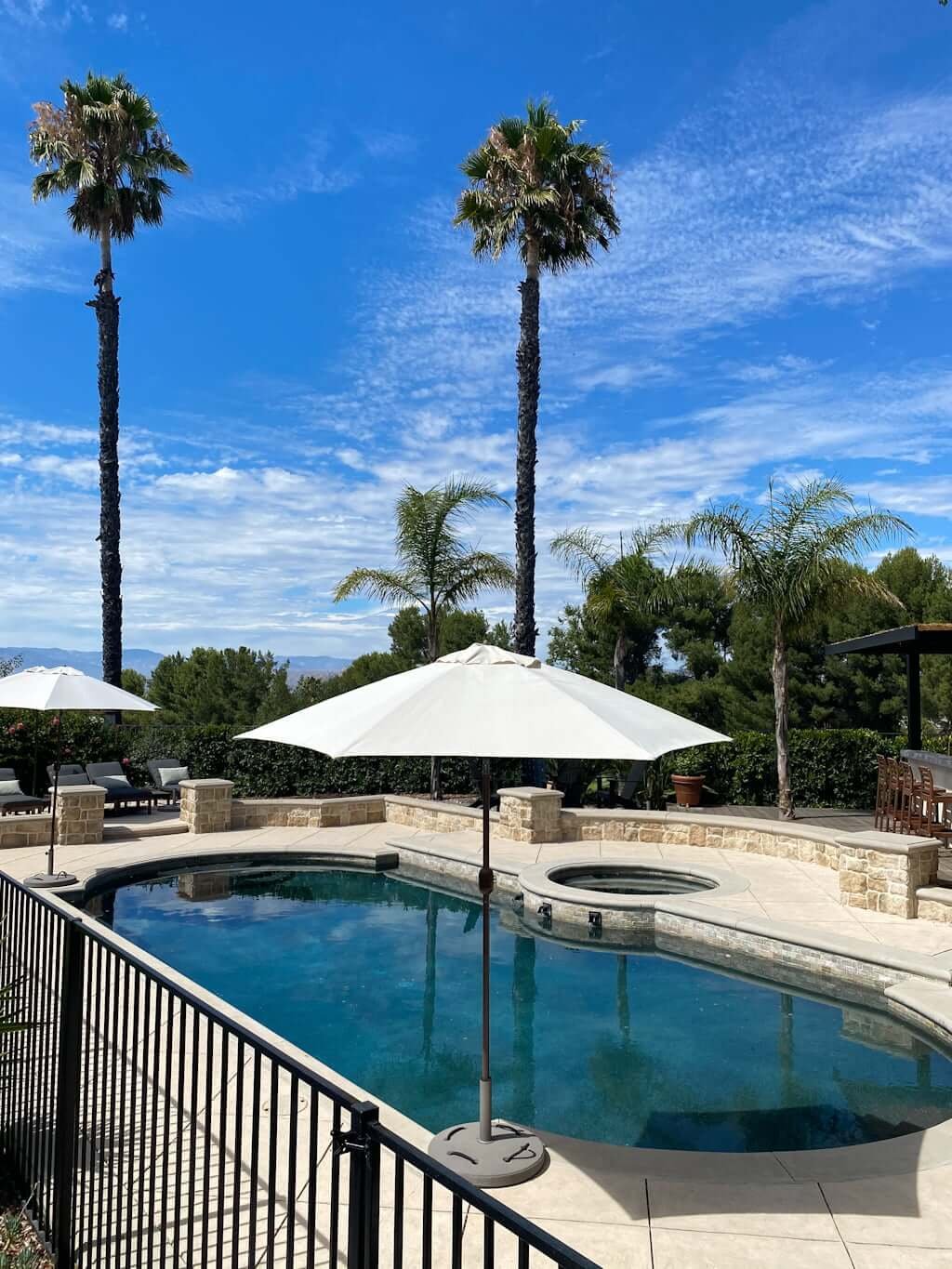 view of pool after makeover and new pool fence