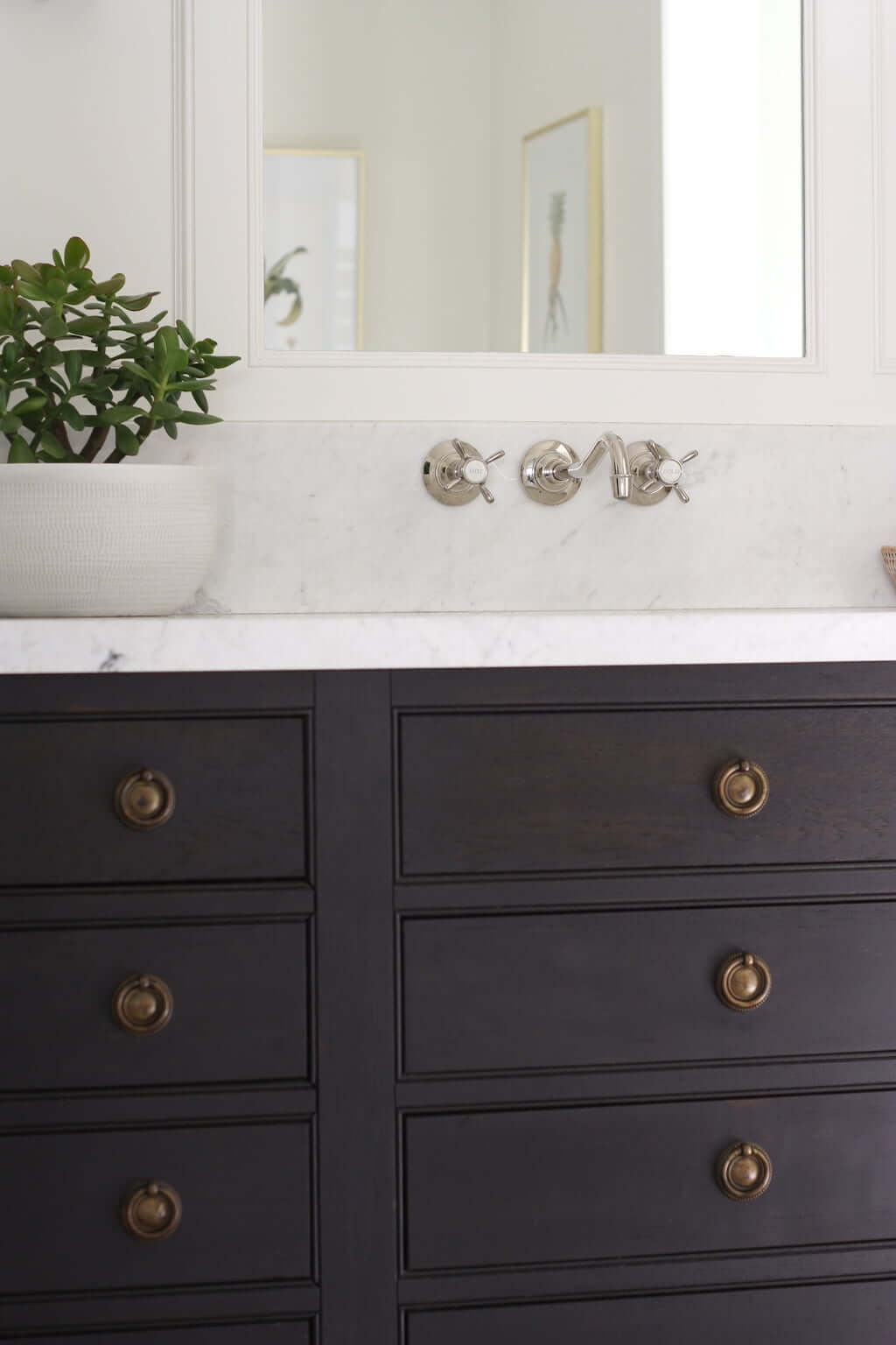 master bathroom double vanity, dark wood with marble and brass ring pulls, wall-mounted faucet in polished nickel