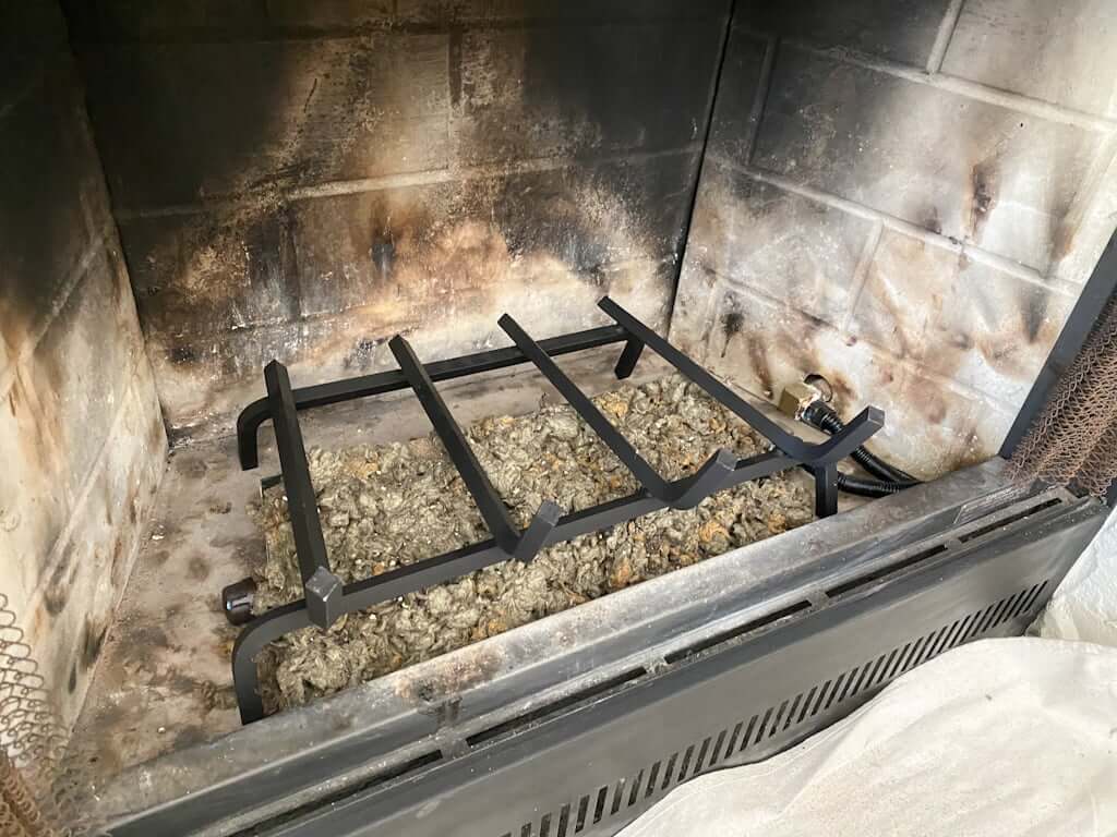 fireplace with gas burner kit, sand, embers, and grate