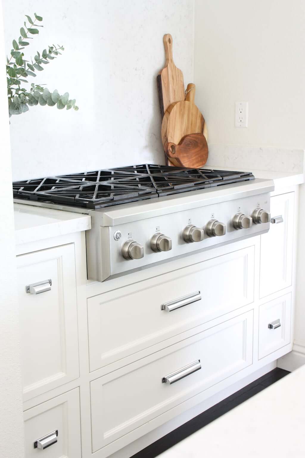white cabinets in kitchen surrounding a gas stove