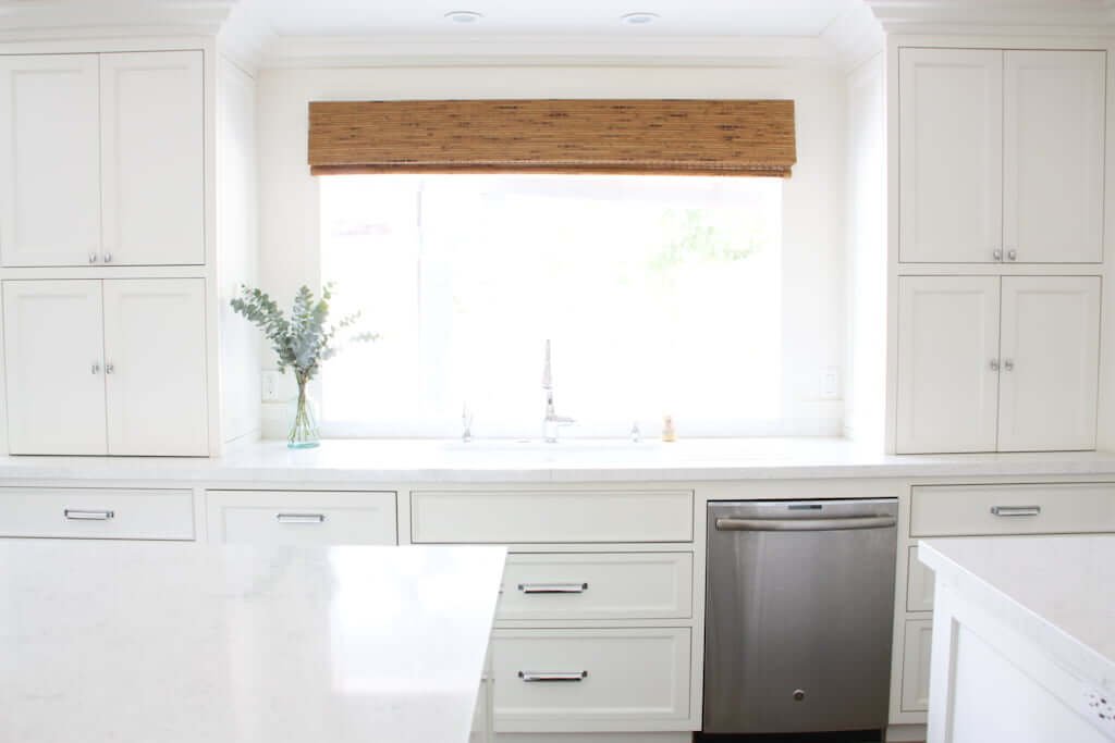 kitchen sink with window, remodel after, with white cabinets surrounding