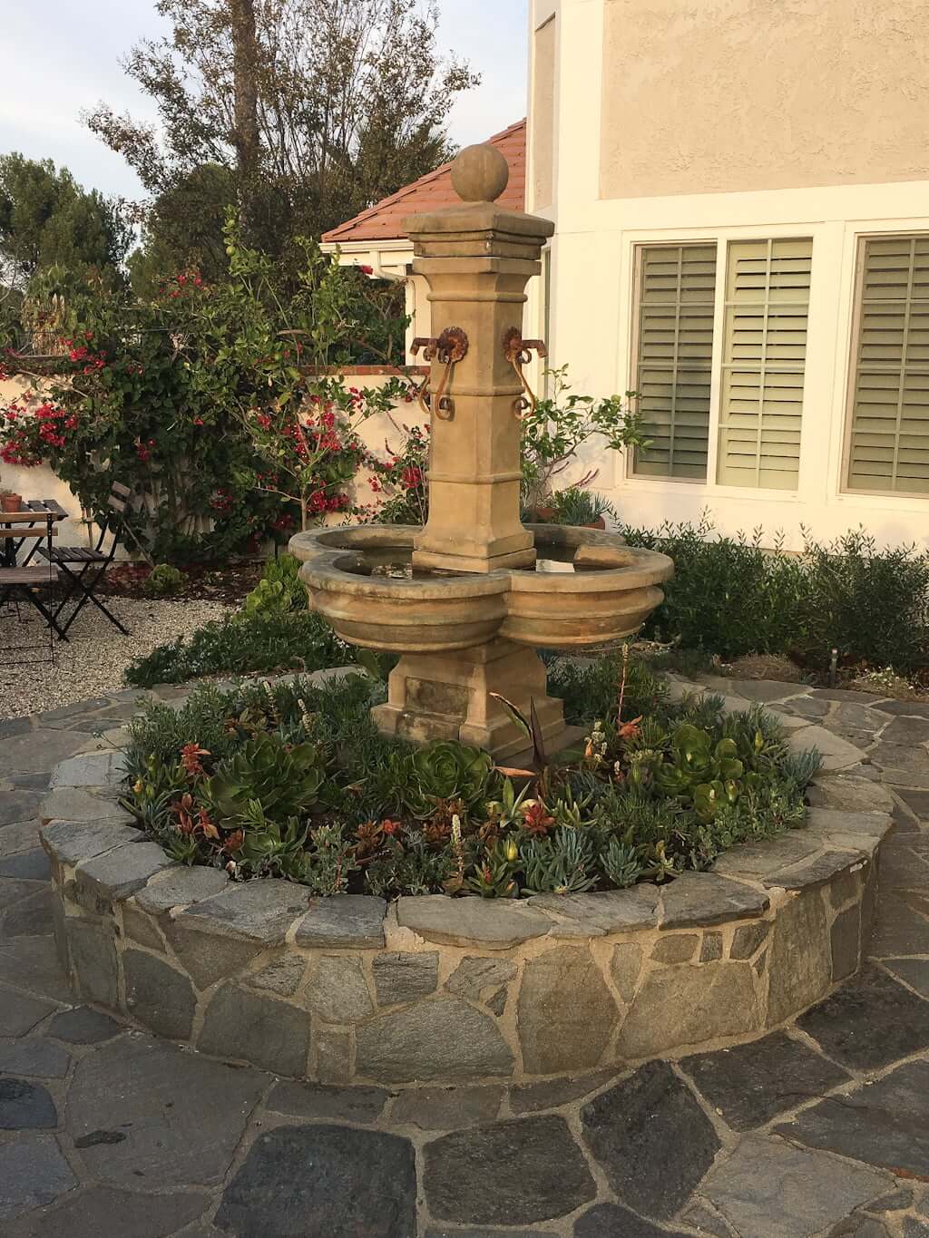 Mediterranean-style fountain in planter with succulents