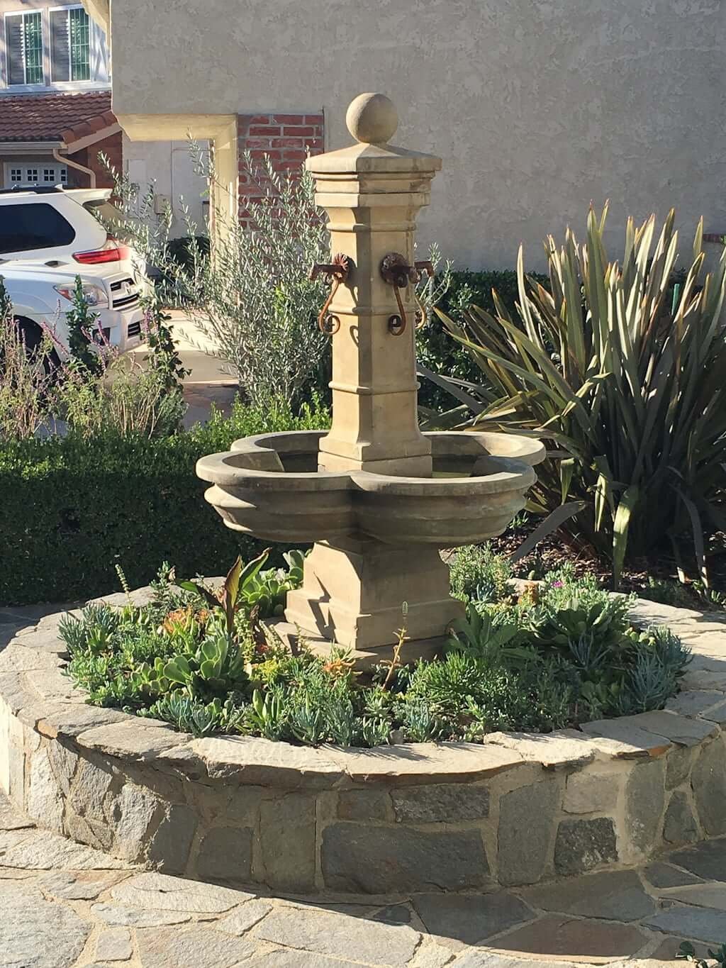 new fountain installed in planter with  succulents