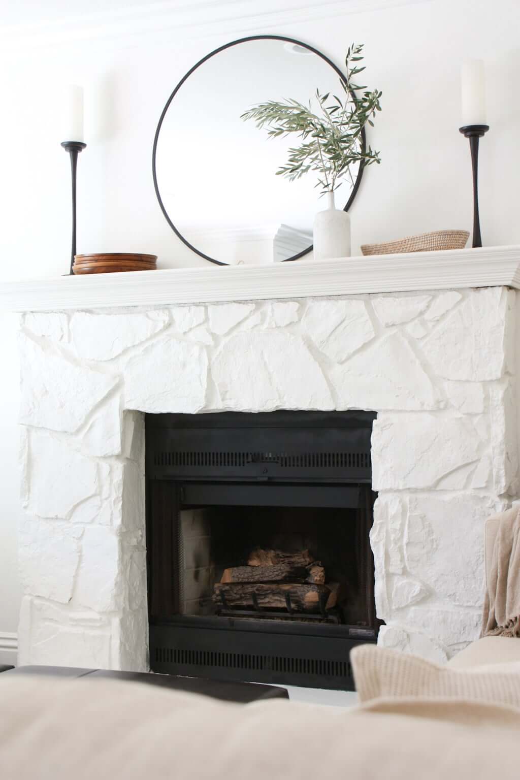 stone fireplace with mantel styled minimally, logs in fireplace