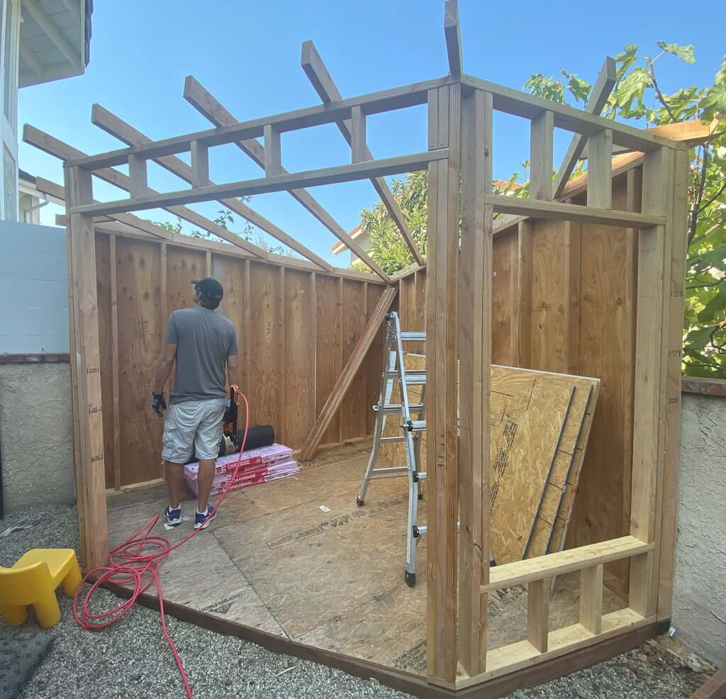art studio shed being built, man looking at shed