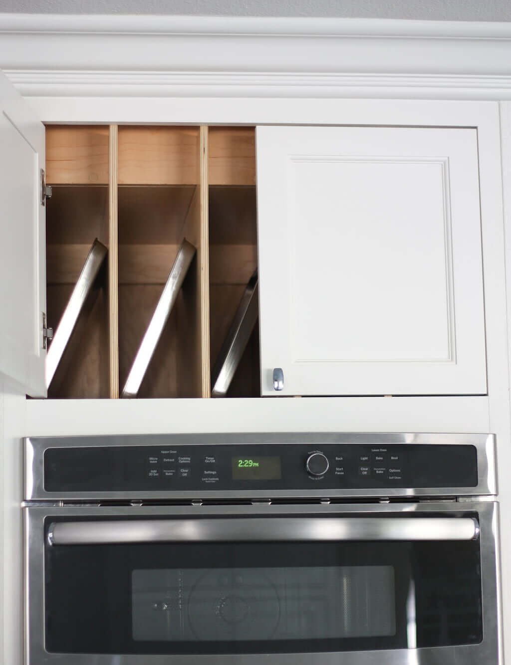 Cabinet above oven with trays separated by built in organization