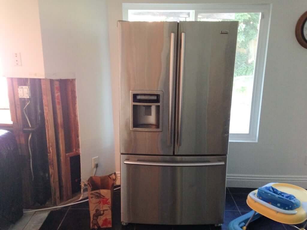 refrigerator out in middle of room