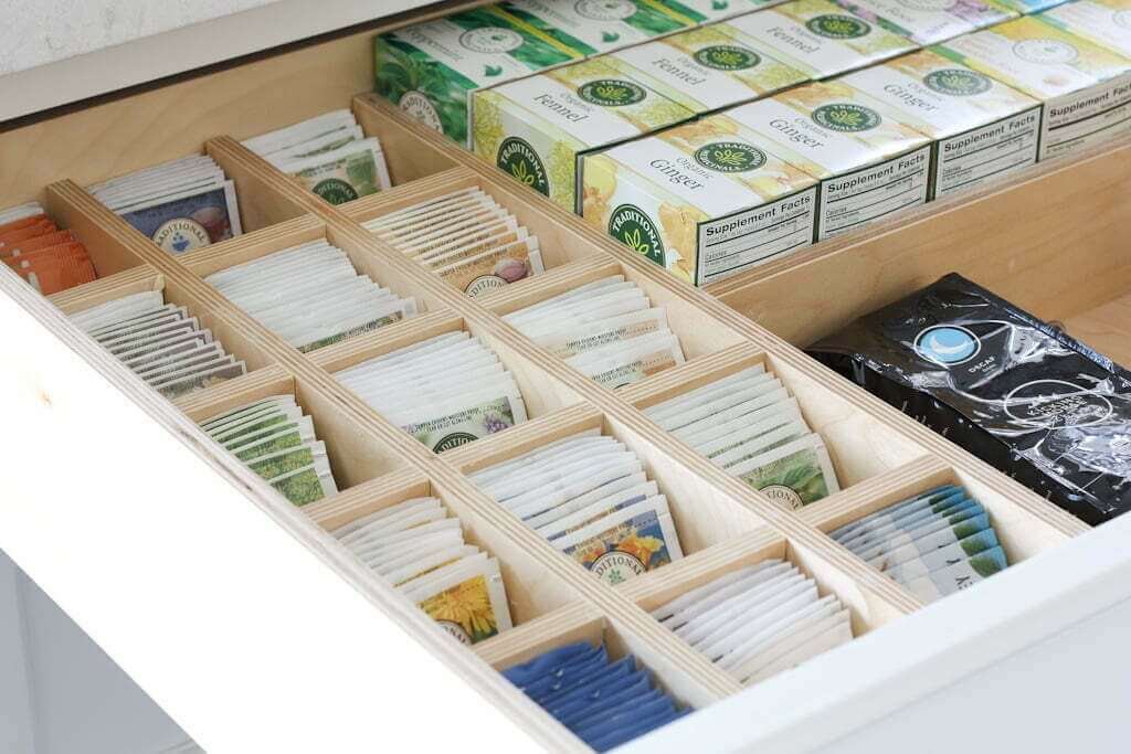 tea bags organized in kitchen drawer with wood dividers