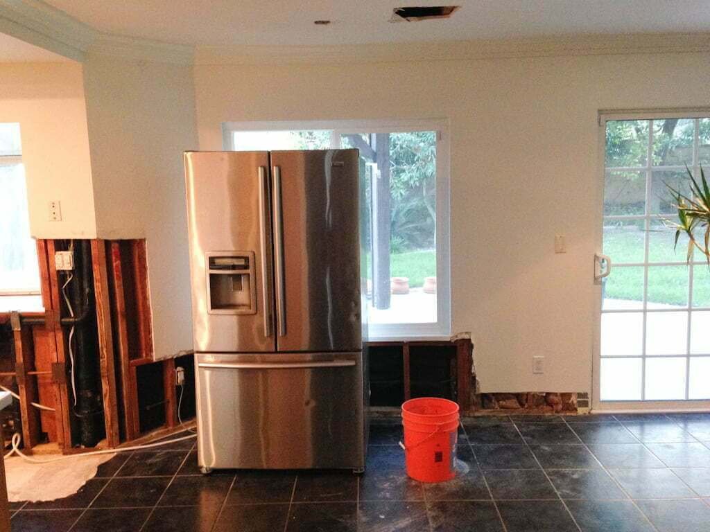 living room with refrigerator in middle of room