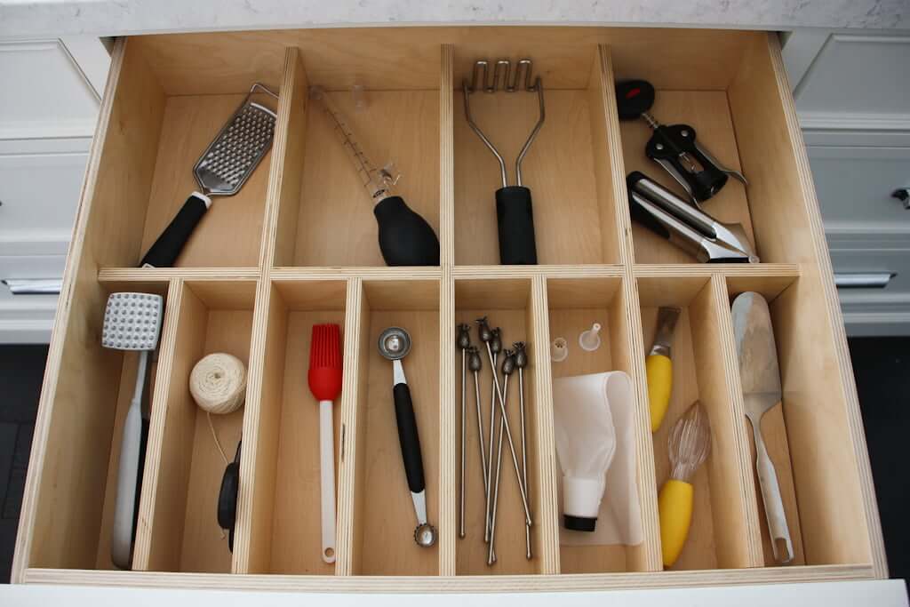 kitchen tools organized in drawer with wood dividers