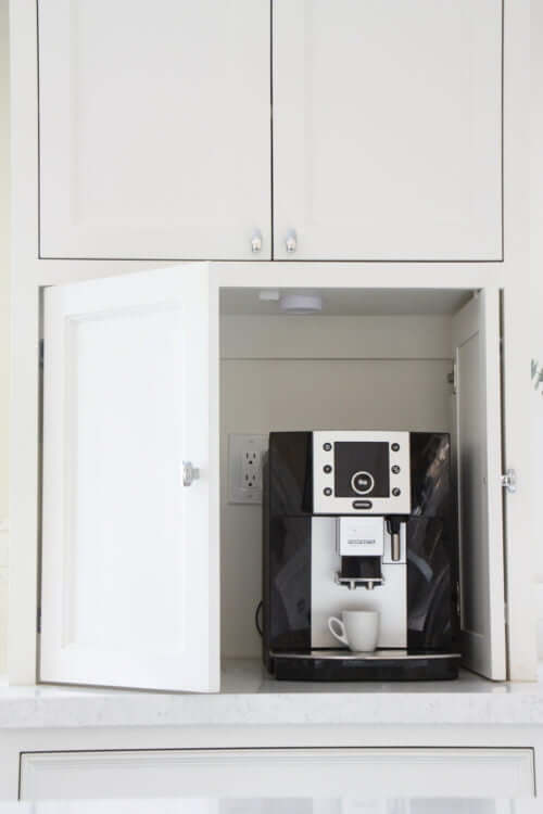 kitchen appliance cabinet with coffee machine inside