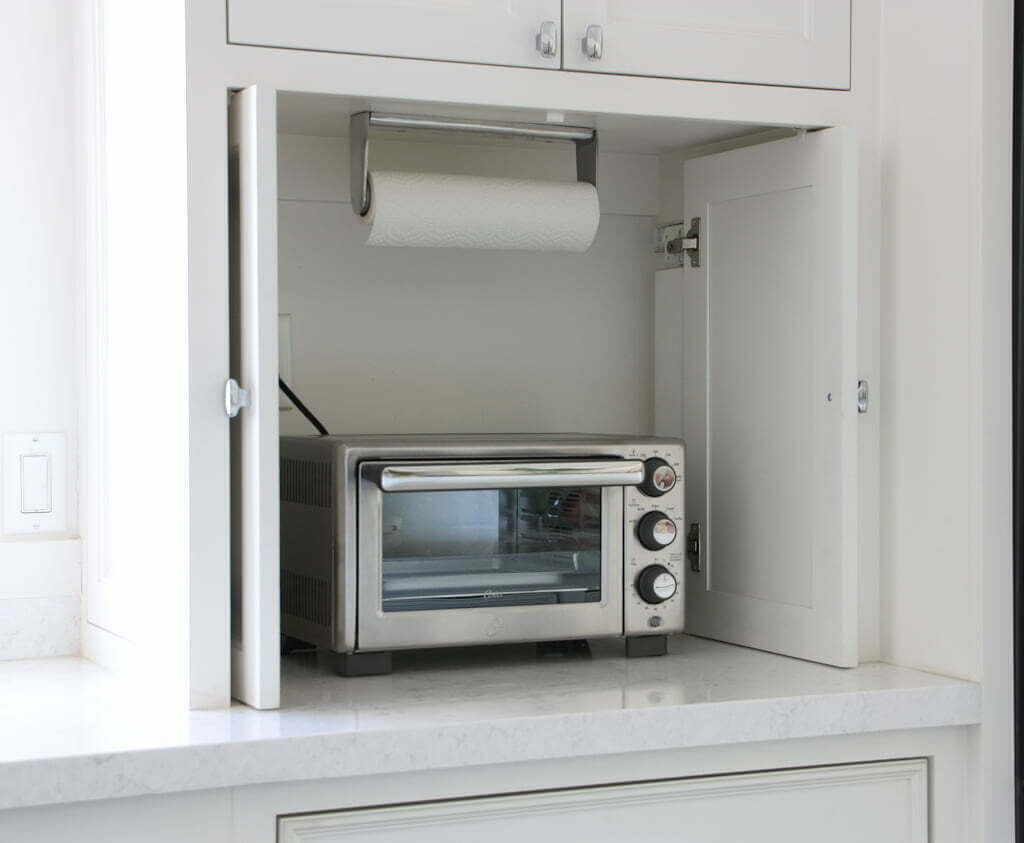 kitchen appliance cabinet storage open, with toaster oven inside